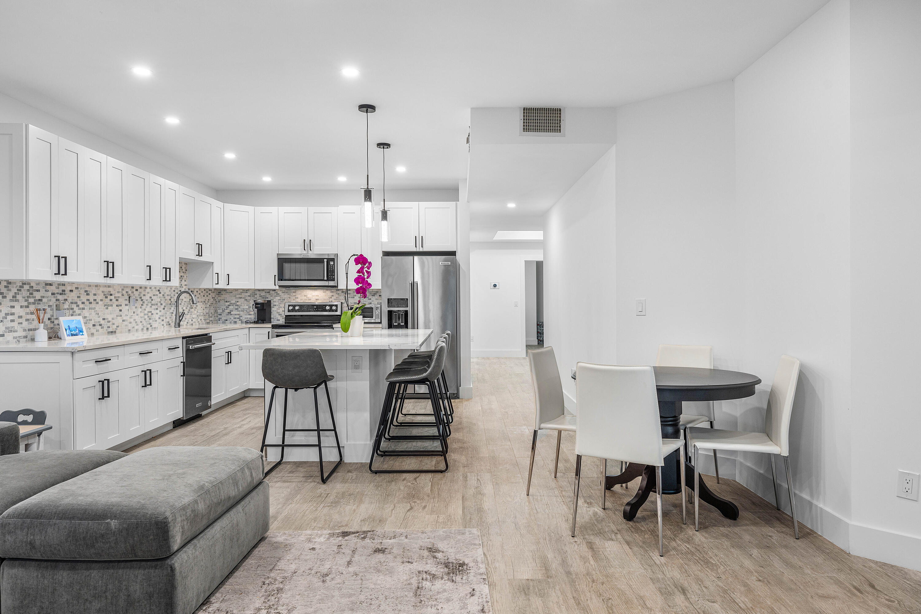6229 Graycliff Drive, Unit A Boca Raton, FL 33496 - Photo 11 of 33 a view of kitchen with stainless steel appliances refrigerator stove dining table and chairs