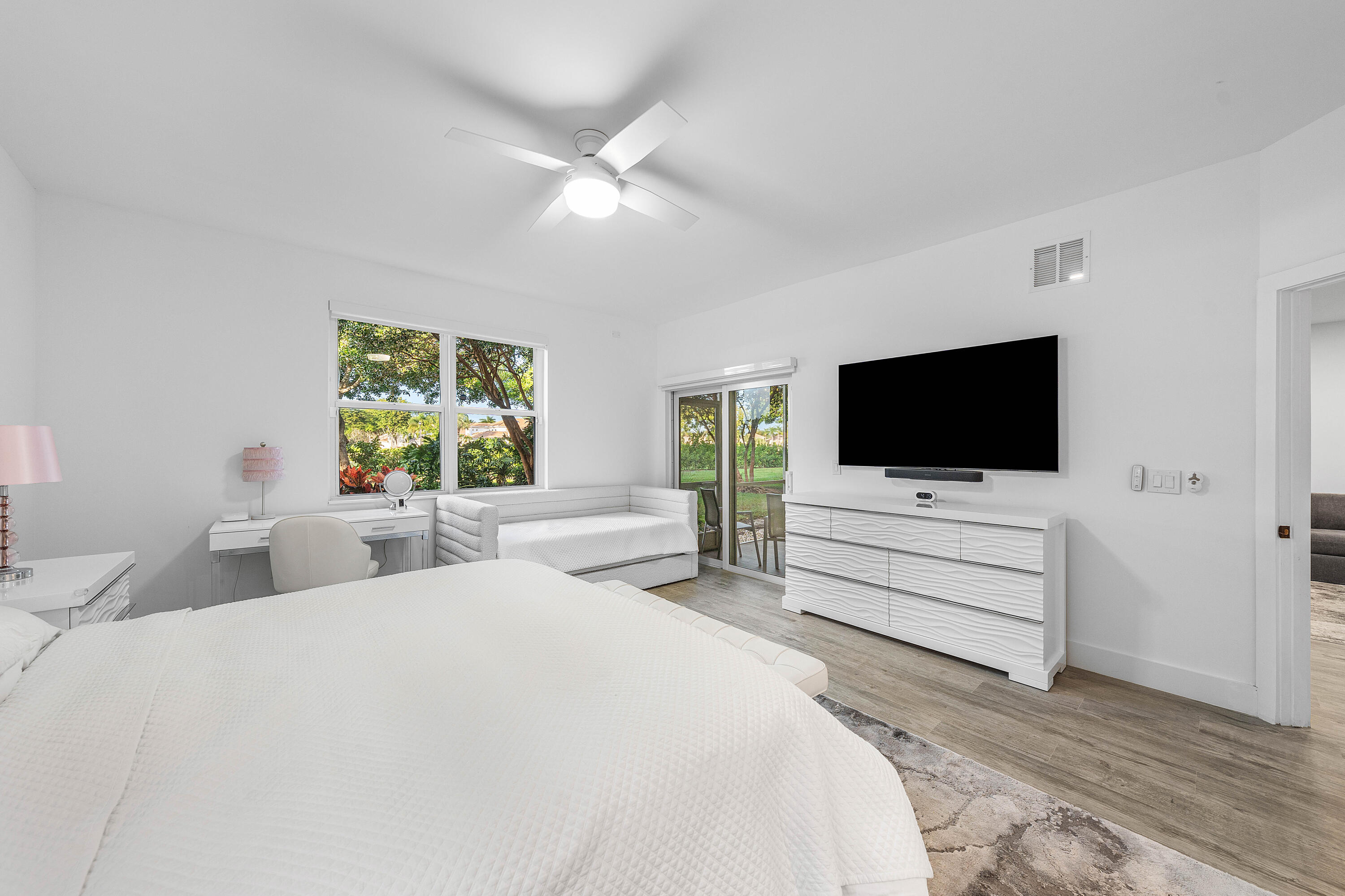 6229 Graycliff Drive, Unit A Boca Raton, FL 33496 - Photo 14 of 33 a bedroom with a flat screen tv and a bed