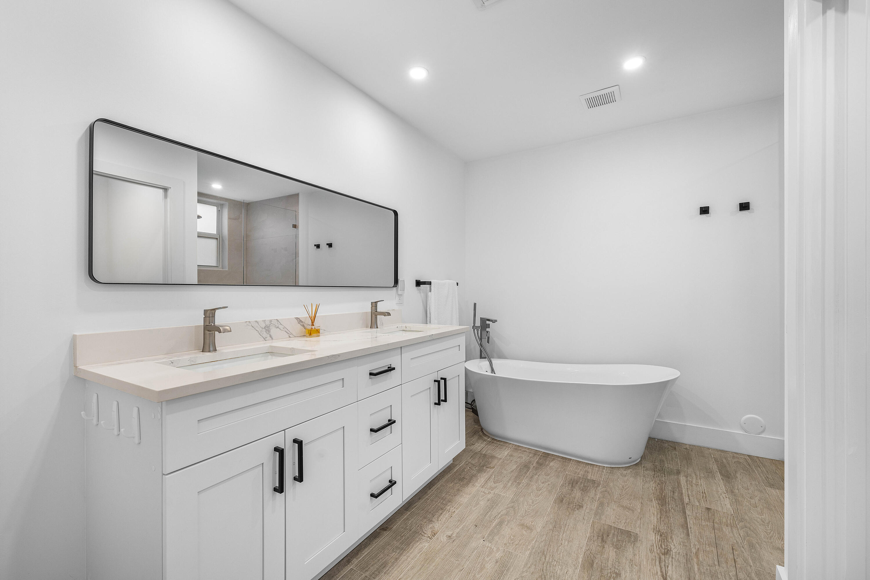 6229 Graycliff Drive, Unit A Boca Raton, FL 33496 - Photo 15 of 33 a bathroom with a toilet sink double vanity and mirror