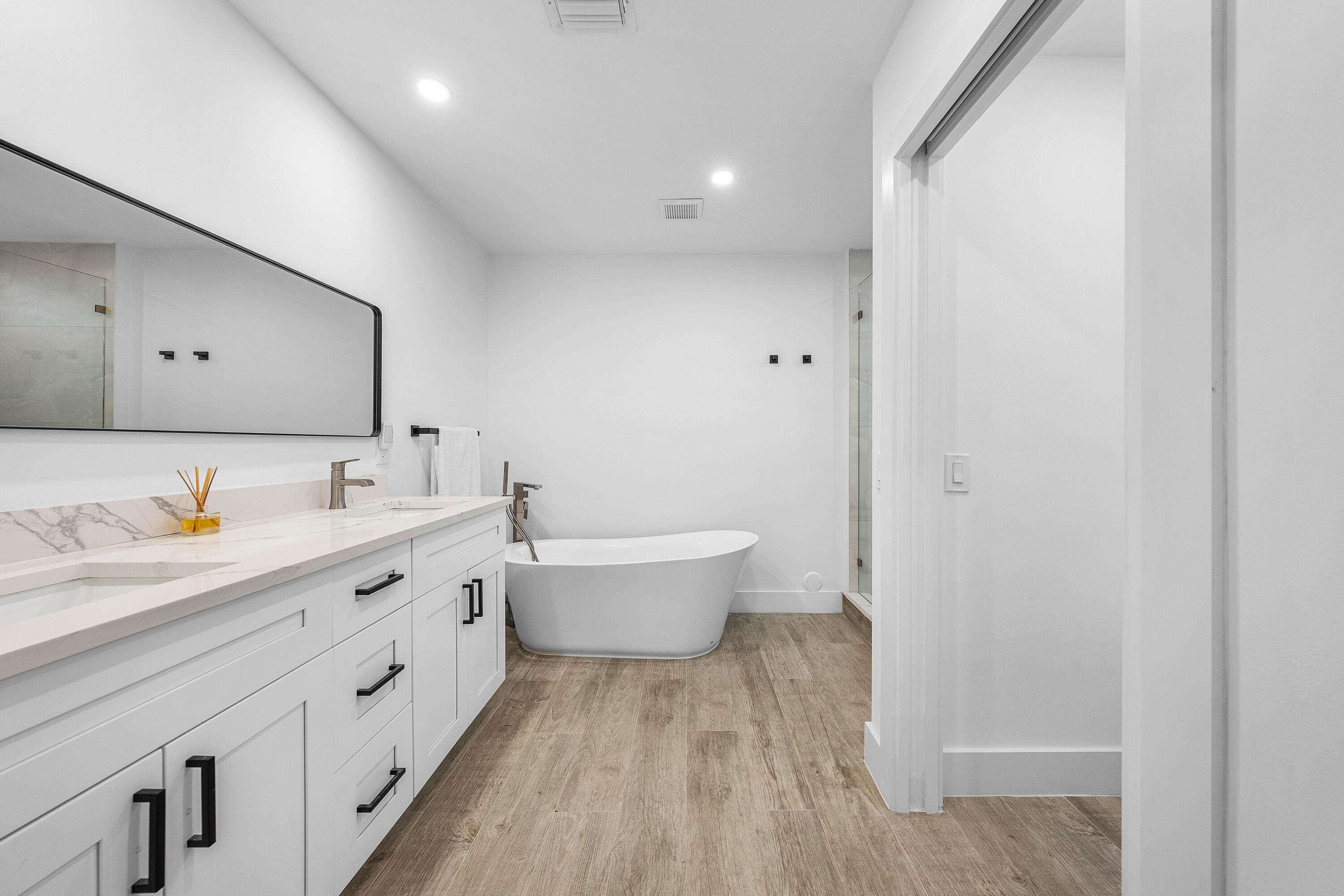 6229 Graycliff Drive, Unit A Boca Raton, FL 33496 - Photo 17 of 33 a bathroom with a double vanity sink and a toilet