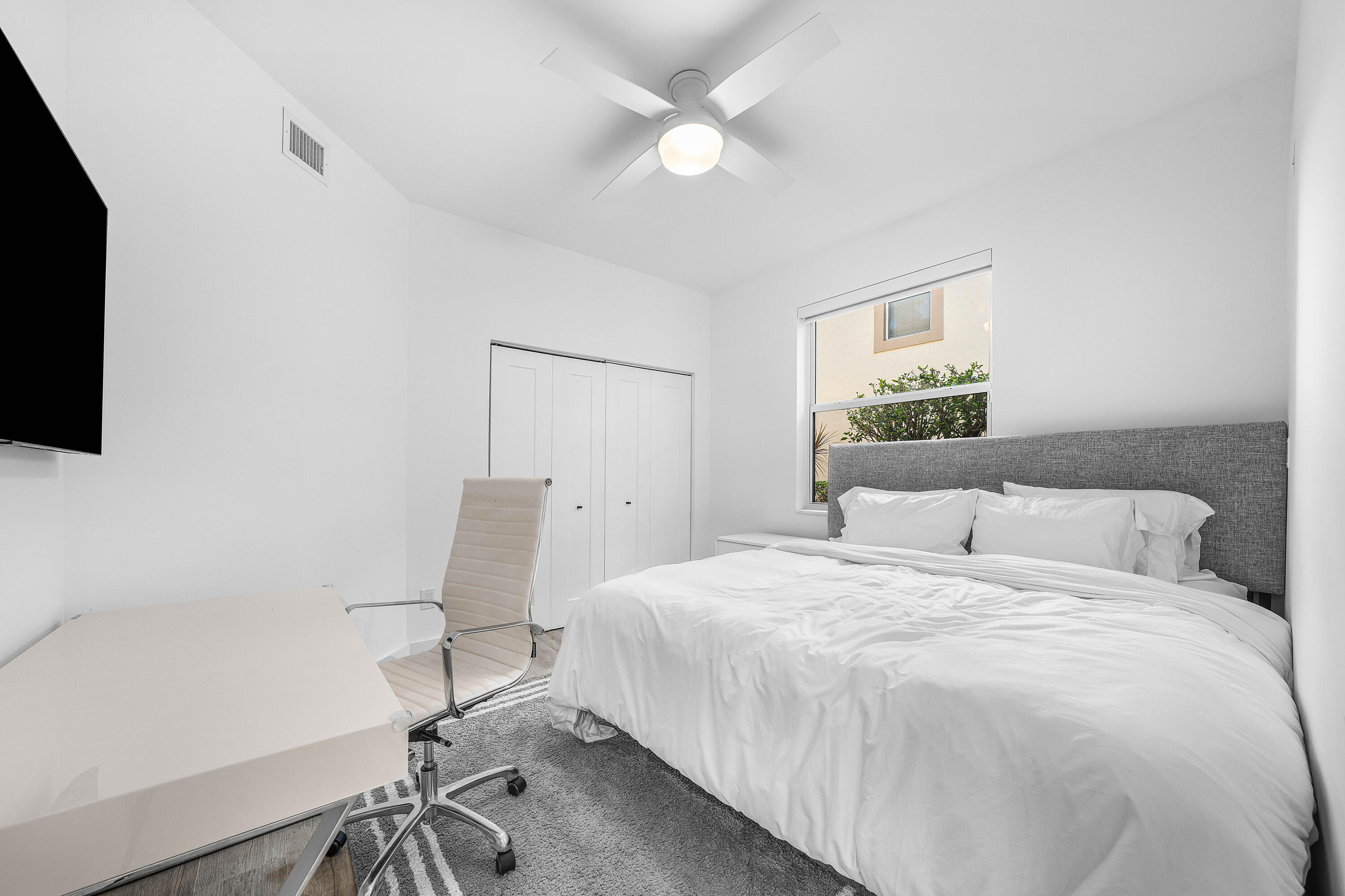 6229 Graycliff Drive, Unit A Boca Raton, FL 33496 - Photo 18 of 33 a bedroom with a bed tv and table