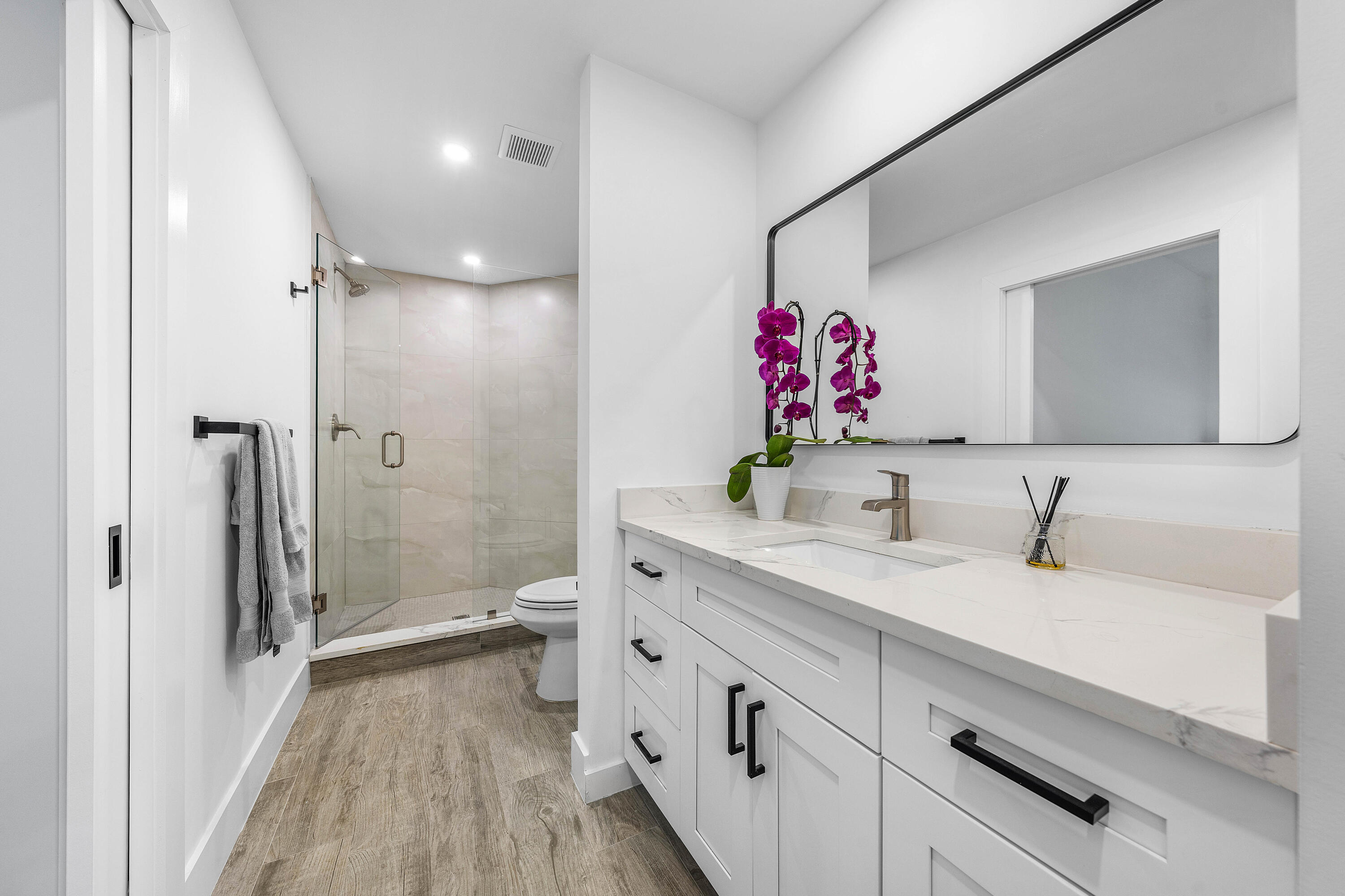 6229 Graycliff Drive, Unit A Boca Raton, FL 33496 - Photo 19 of 33 a spacious bathroom with a shower sink vanity mirror and toilet