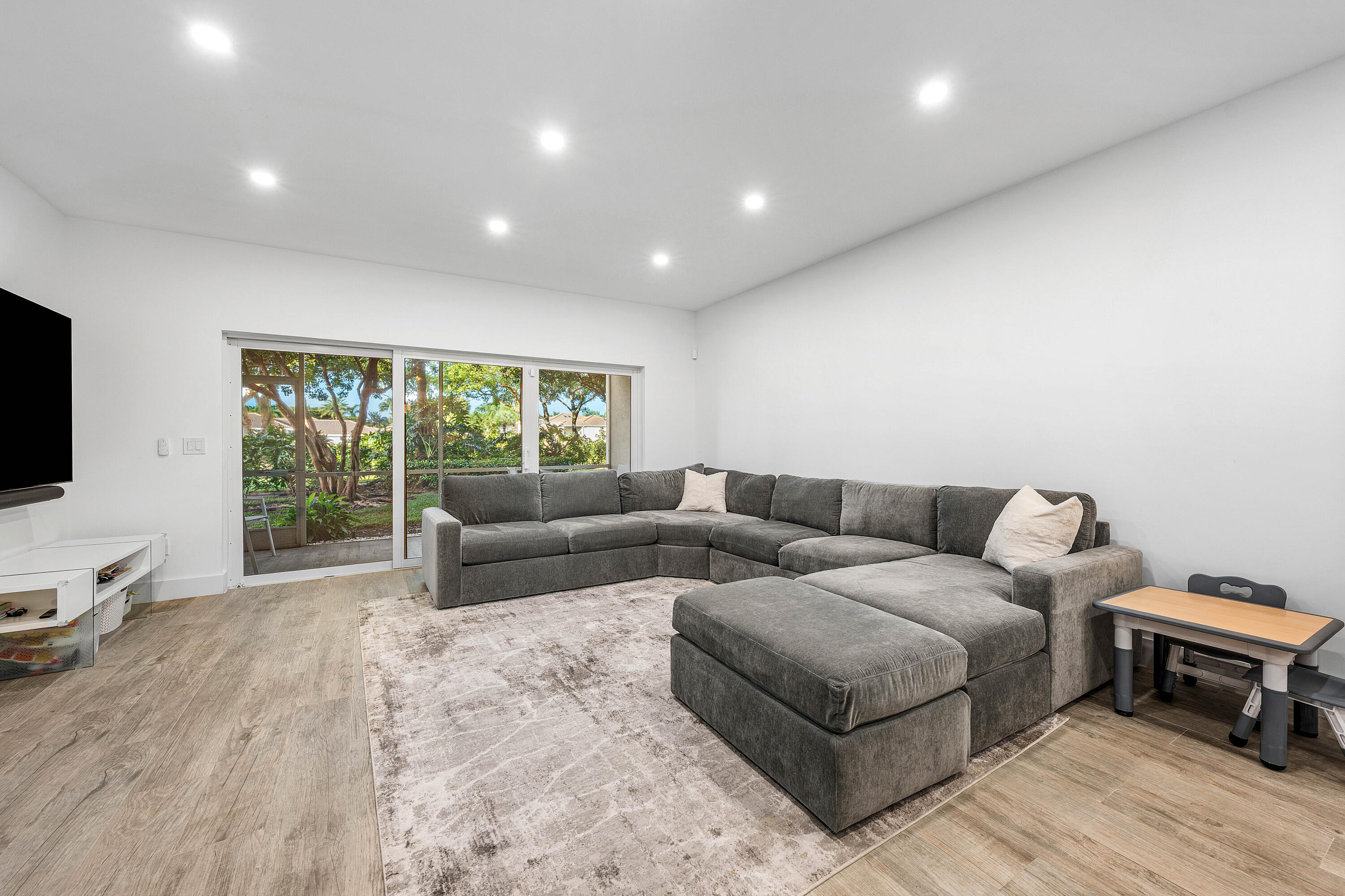 6229 Graycliff Drive, Unit A Boca Raton, FL 33496 - Photo 8 of 33 a living room with furniture and a flat screen tv