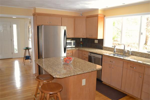 370 North Emerson Road Lexington, MA 02420 - Photo 3 of 30 a kitchen with stainless steel appliances granite countertop a sink a refrigerator and a granite counter tops with white cabinets