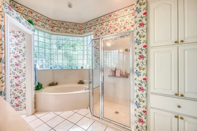 a bathroom with a bathtub and shower
