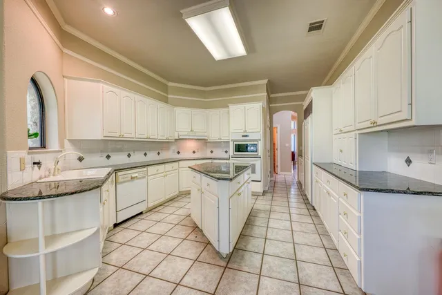a kitchen with a sink stove and cabinets