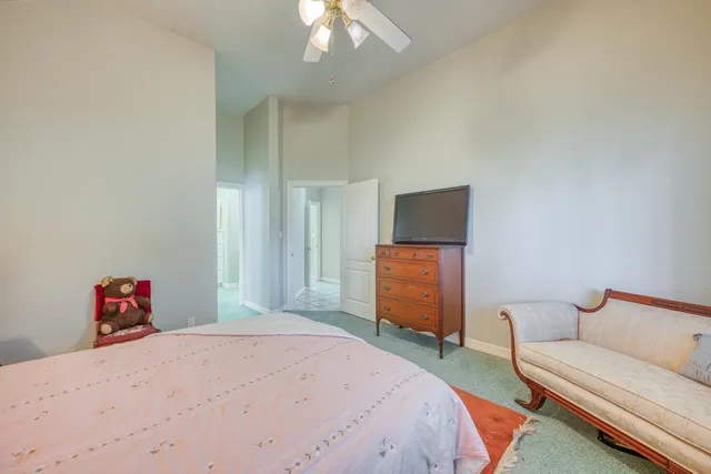 a bedroom with a bed and a chandelier