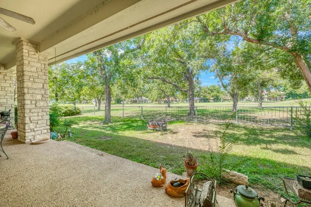 a view of a park with furniture and garden