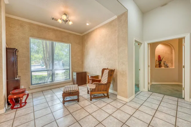 a living room with furniture and large windows