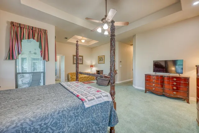 a bedroom with a bed and a dresser in it