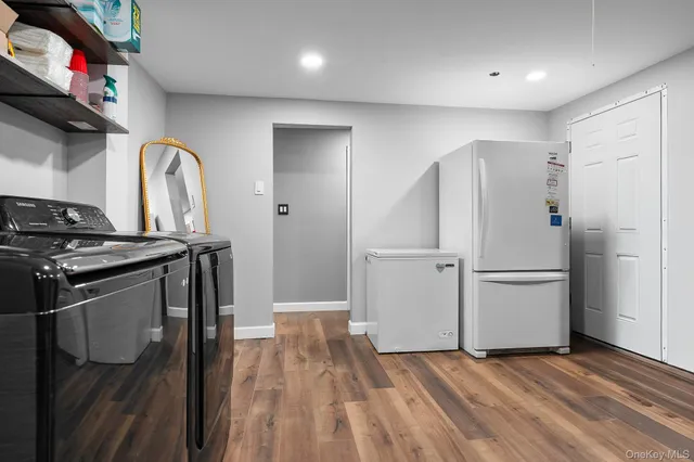 a kitchen with stainless steel appliances granite countertop a refrigerator sink and wooden floor