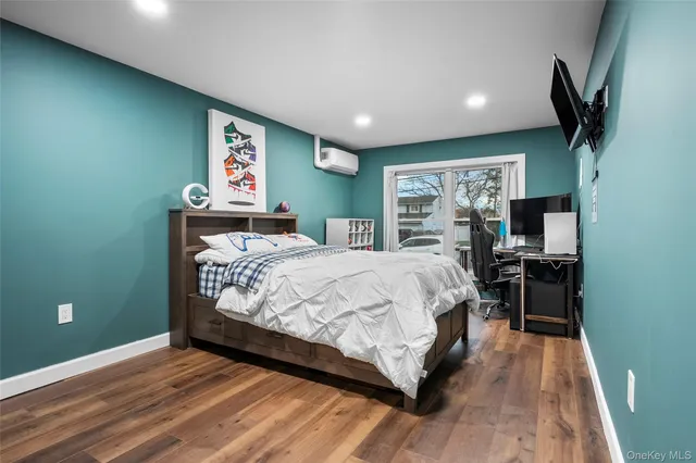 a bed sitting in a bedroom next to a window