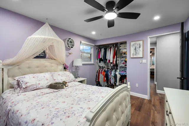 a bedroom with a bed and a large mirror