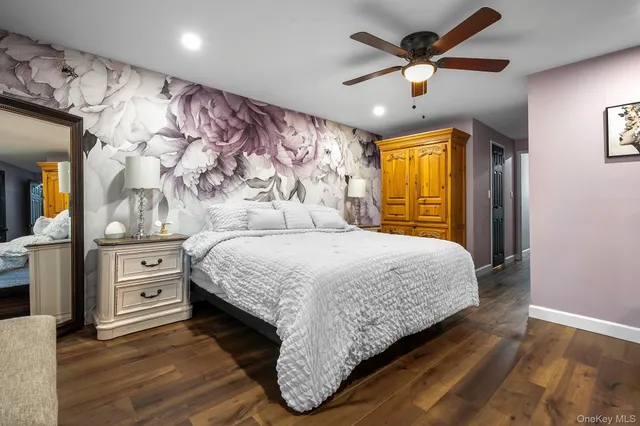 a bedroom with a large bed and a chandelier