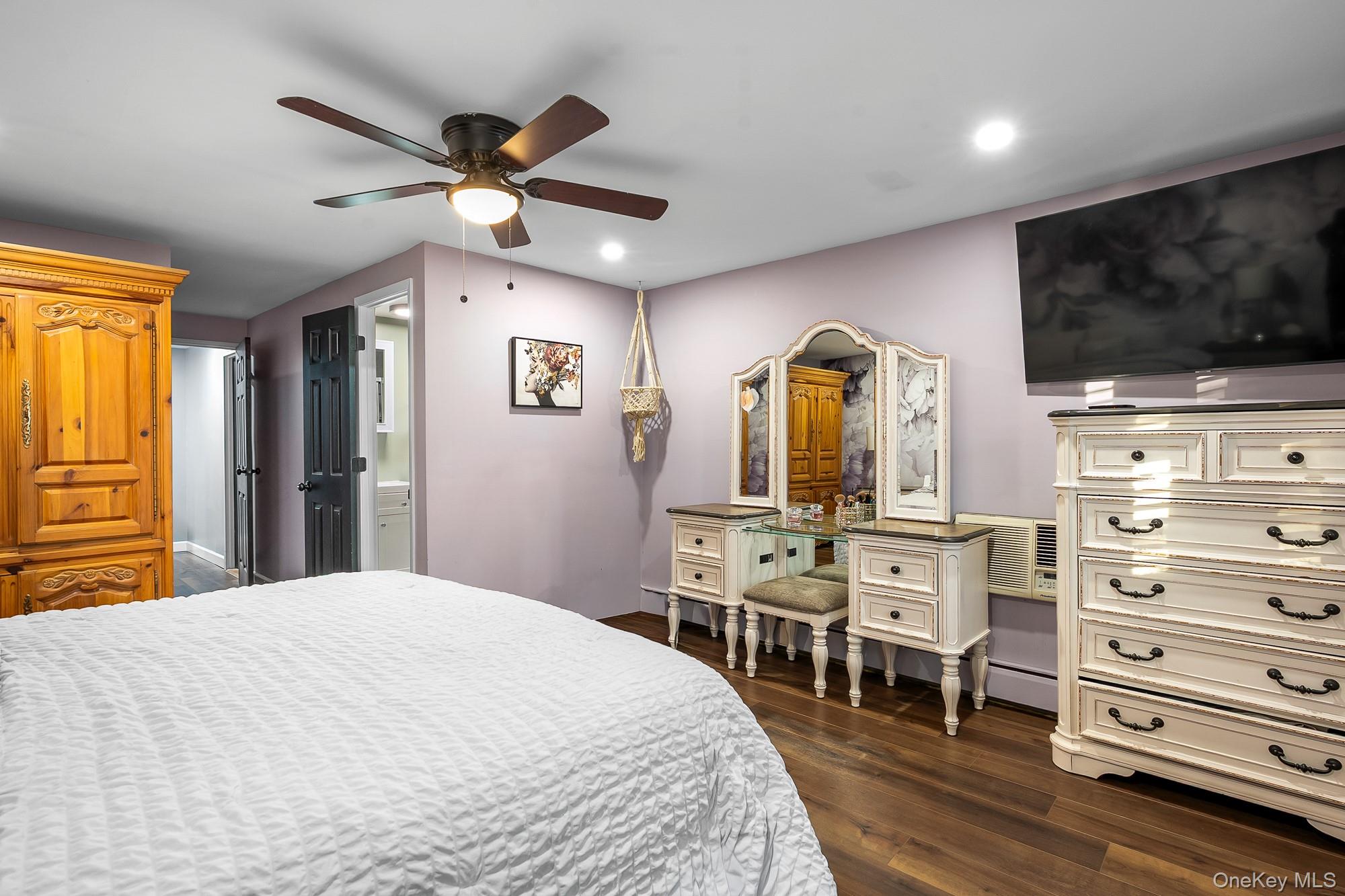 19 Corvette Road Selden, NY 11784 - Photo 23 of 28 Bedroom featuring dark wood-style flooring, a ceiling fan, a baseboard heating unit, and recessed lighting