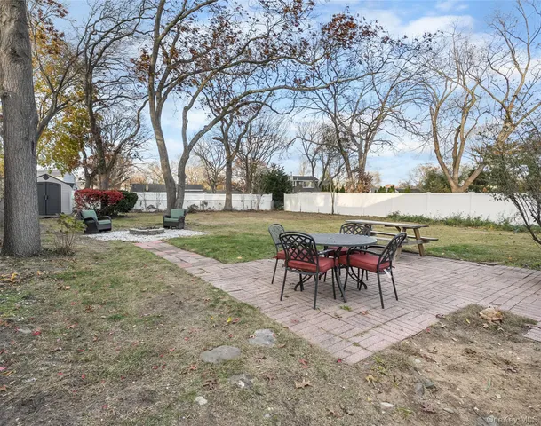 a view of a yard with a table and chairs