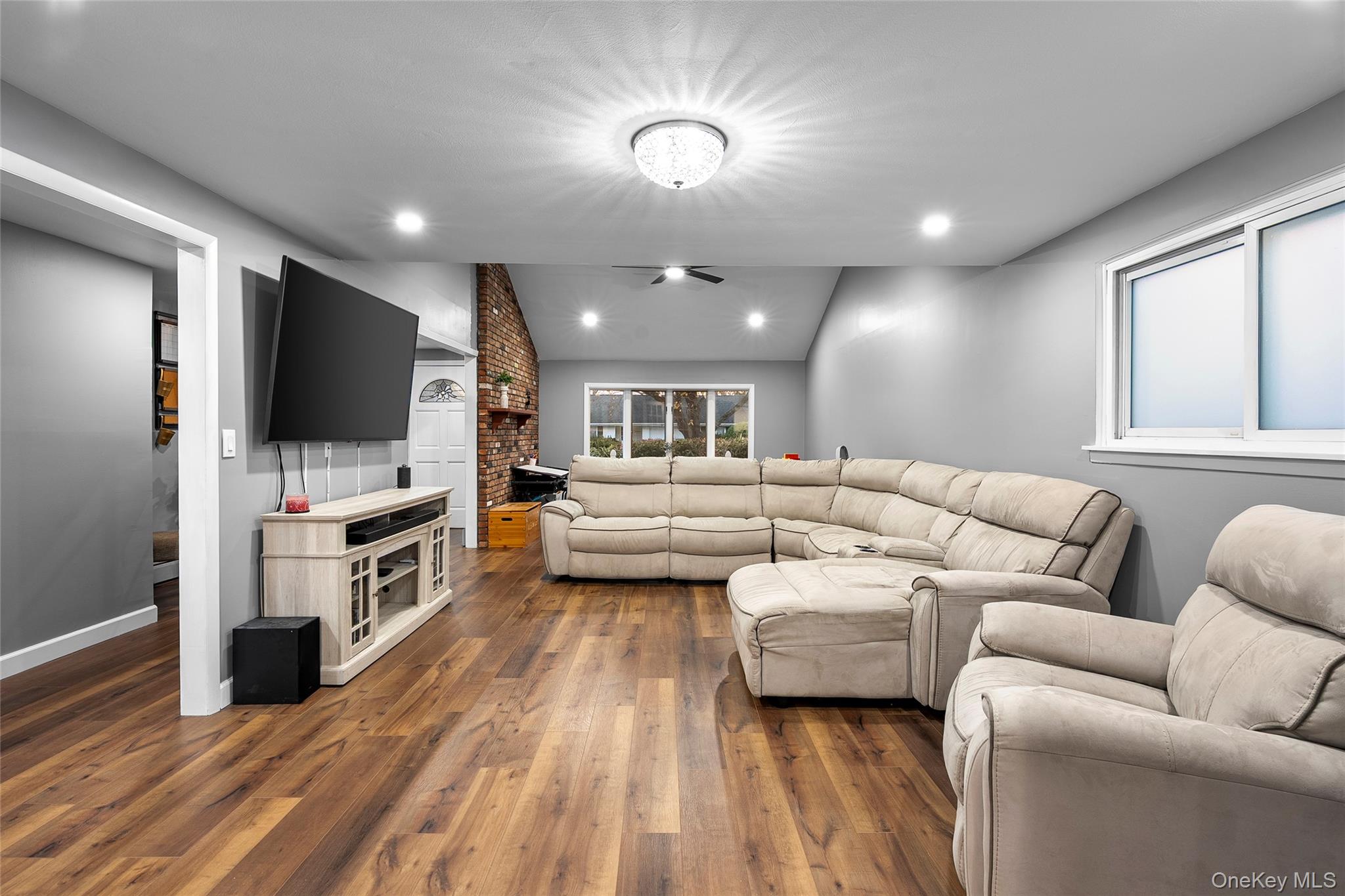 19 Corvette Road Selden, NY 11784 - Photo 6 of 28 Living area with dark wood-type flooring, recessed lighting, and vaulted ceiling