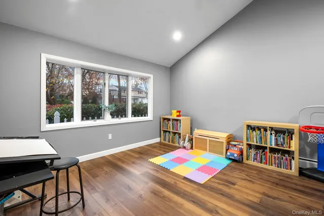 a living room with furniture and a book shelf