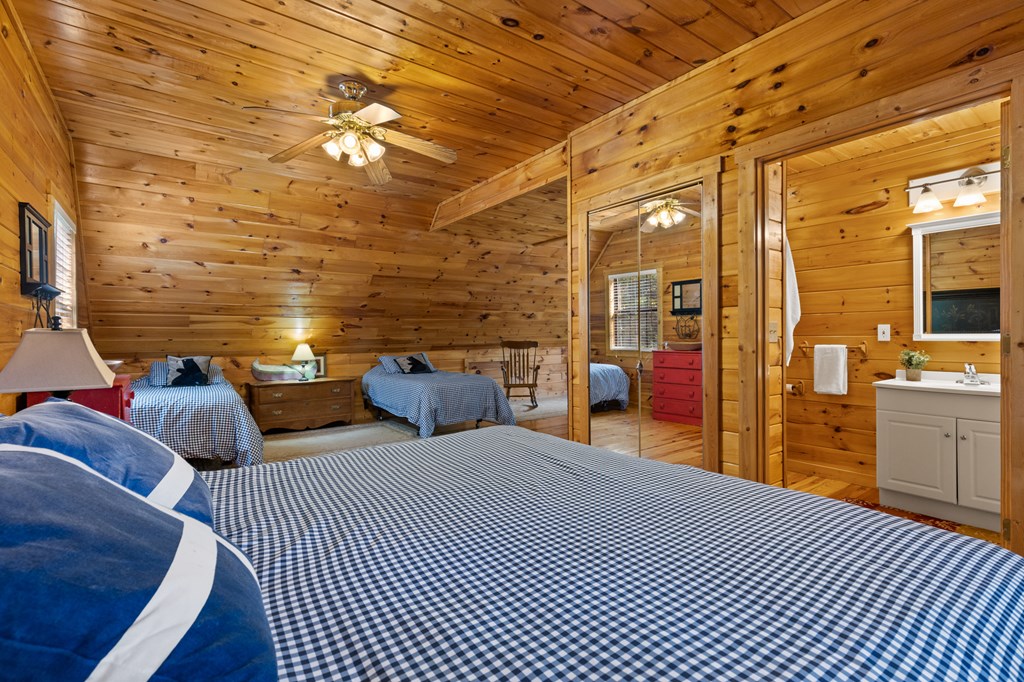 96 Holiday Court Ellijay, GA 30540 - Photo 28 of 51 a bedroom with a bed and wooden floor