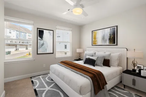 a bedroom with a bed and a window