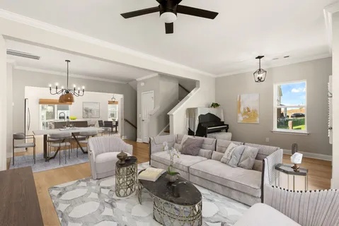 a living room with furniture and a chandelier