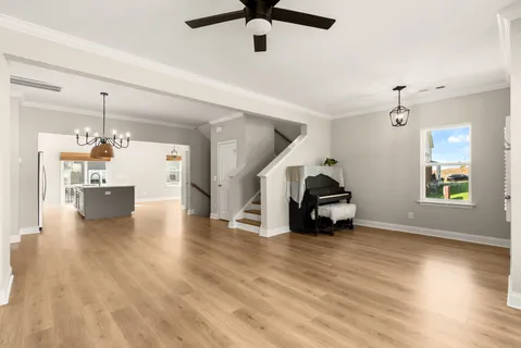 a living room with furniture and a chandelier