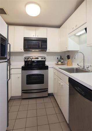 197 8th Street, Unit 501 Boston, MA 02129 - Photo 6 of 9 a kitchen with a stove a sink and a microwave
