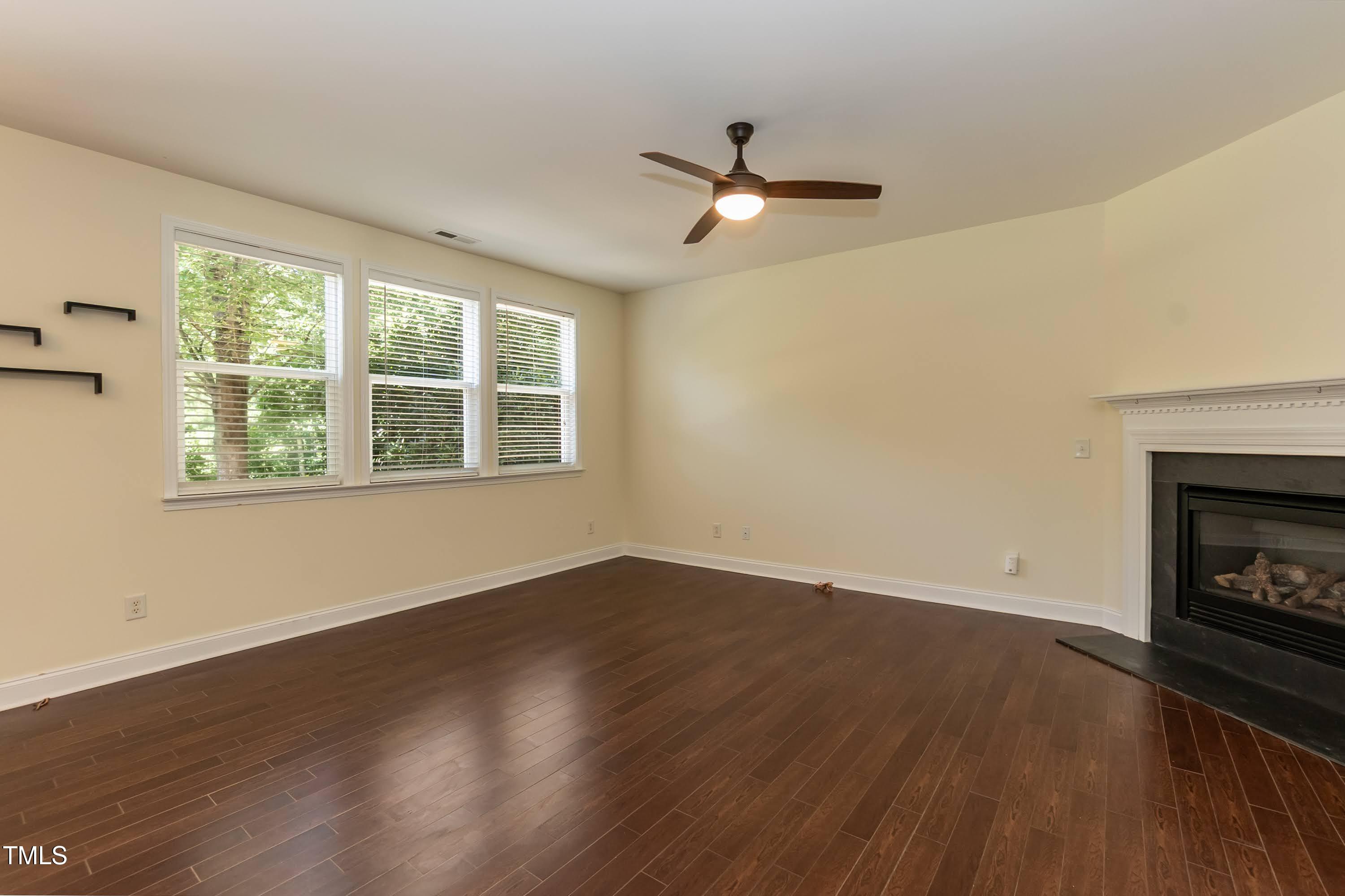 418 Byrams Ford Drive Cary, NC 27513 - Photo 9 of 53 a view of wooden floor fire place refrigerator and window in a room