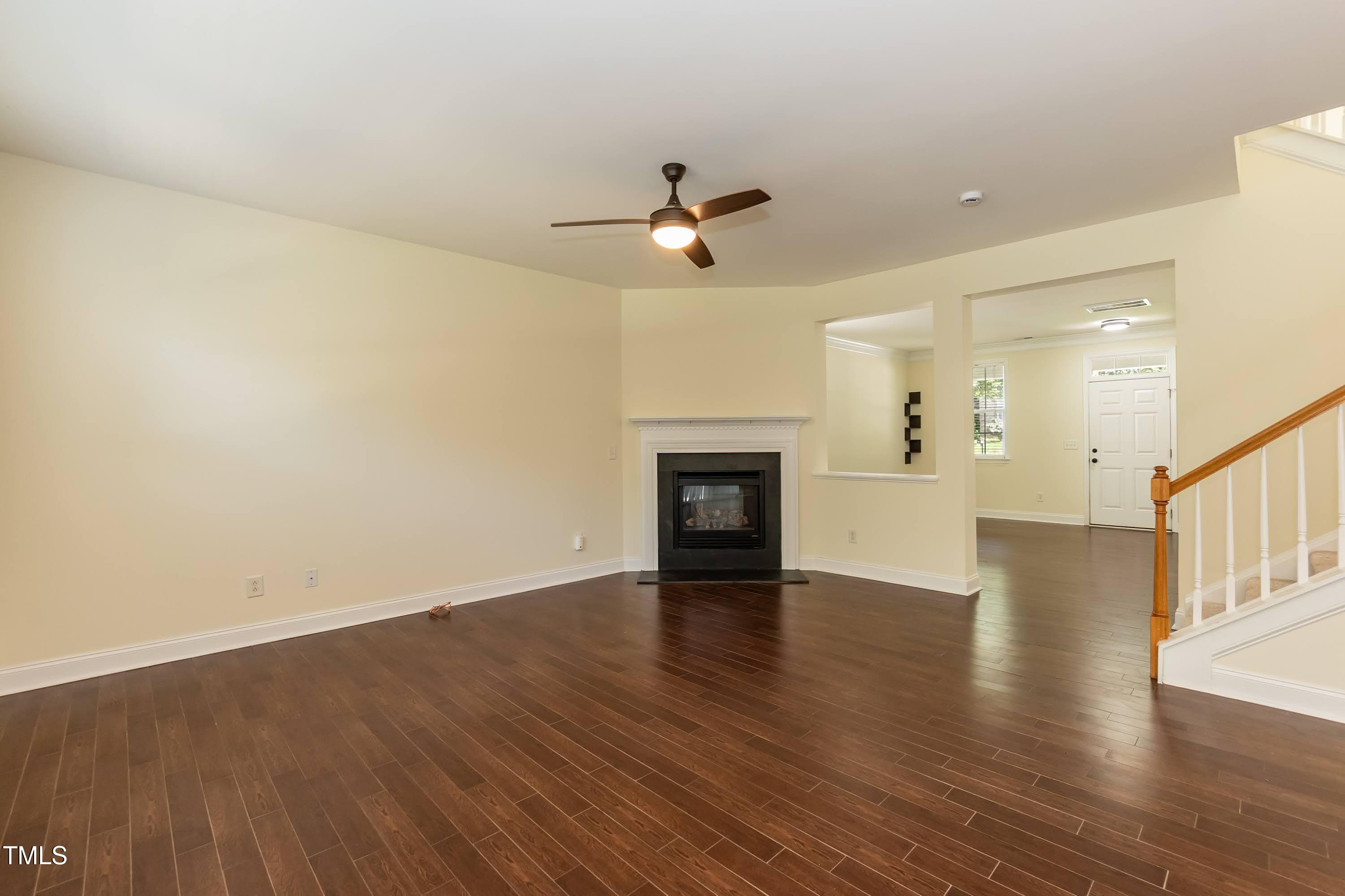 418 Byrams Ford Drive Cary, NC 27513 - Photo 10 of 53 a view of empty room with wooden floor and ceiling fan