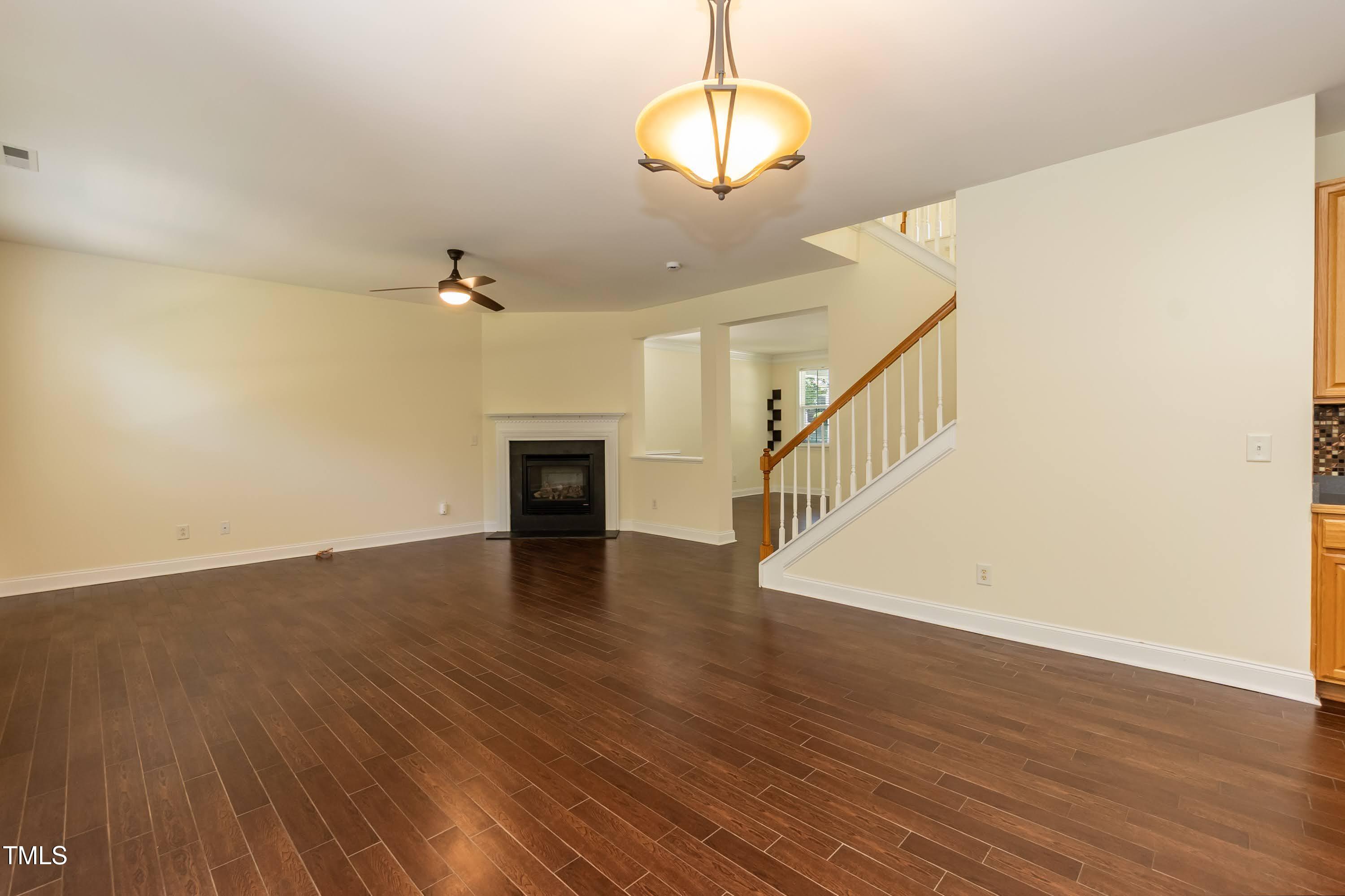 418 Byrams Ford Drive Cary, NC 27513 - Photo 14 of 53 a view of an empty room with wooden floor and a chandelier