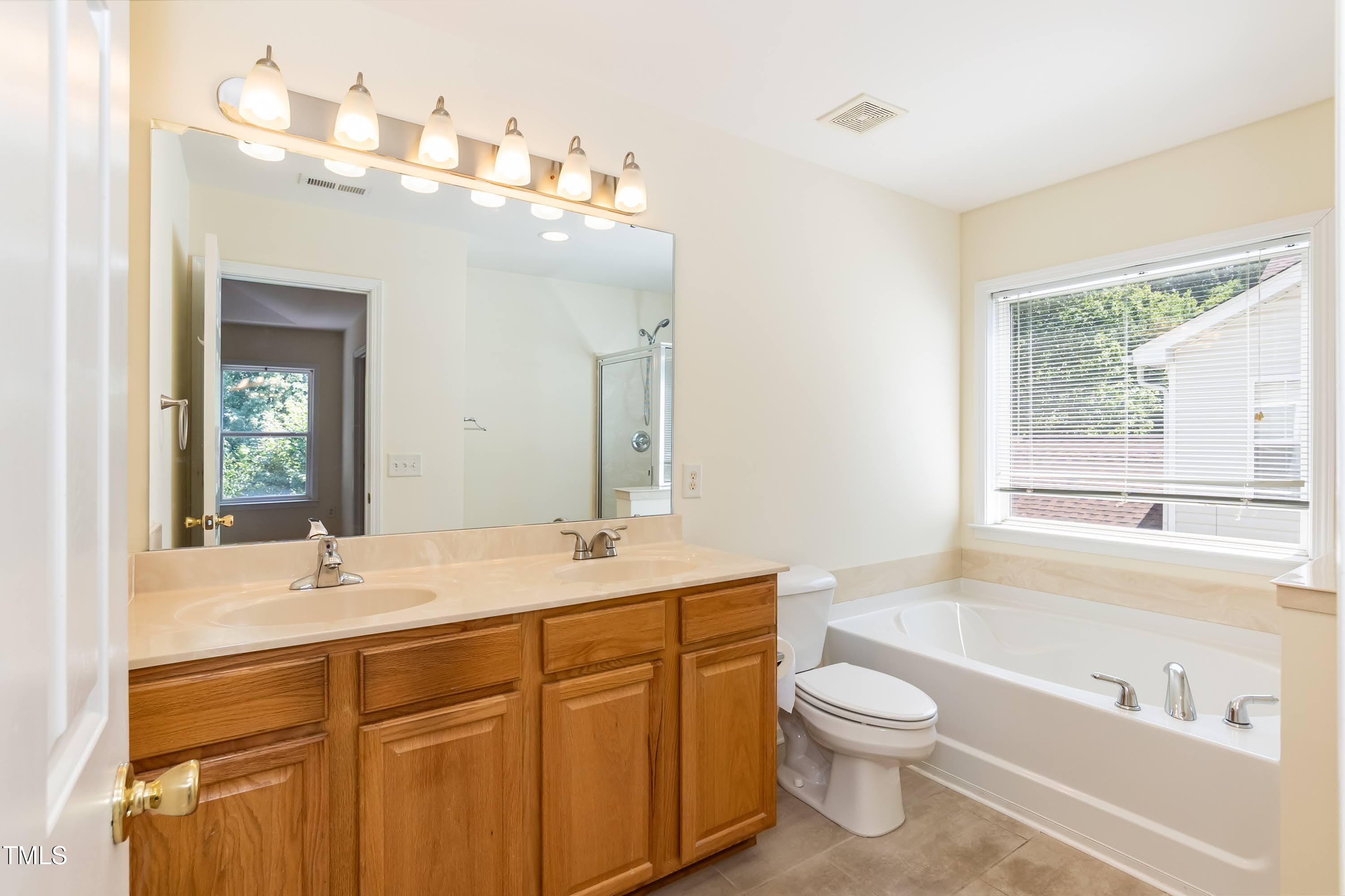418 Byrams Ford Drive Cary, NC 27513 - Photo 25 of 53 a bathroom with a granite countertop sink a toilet and bathtub