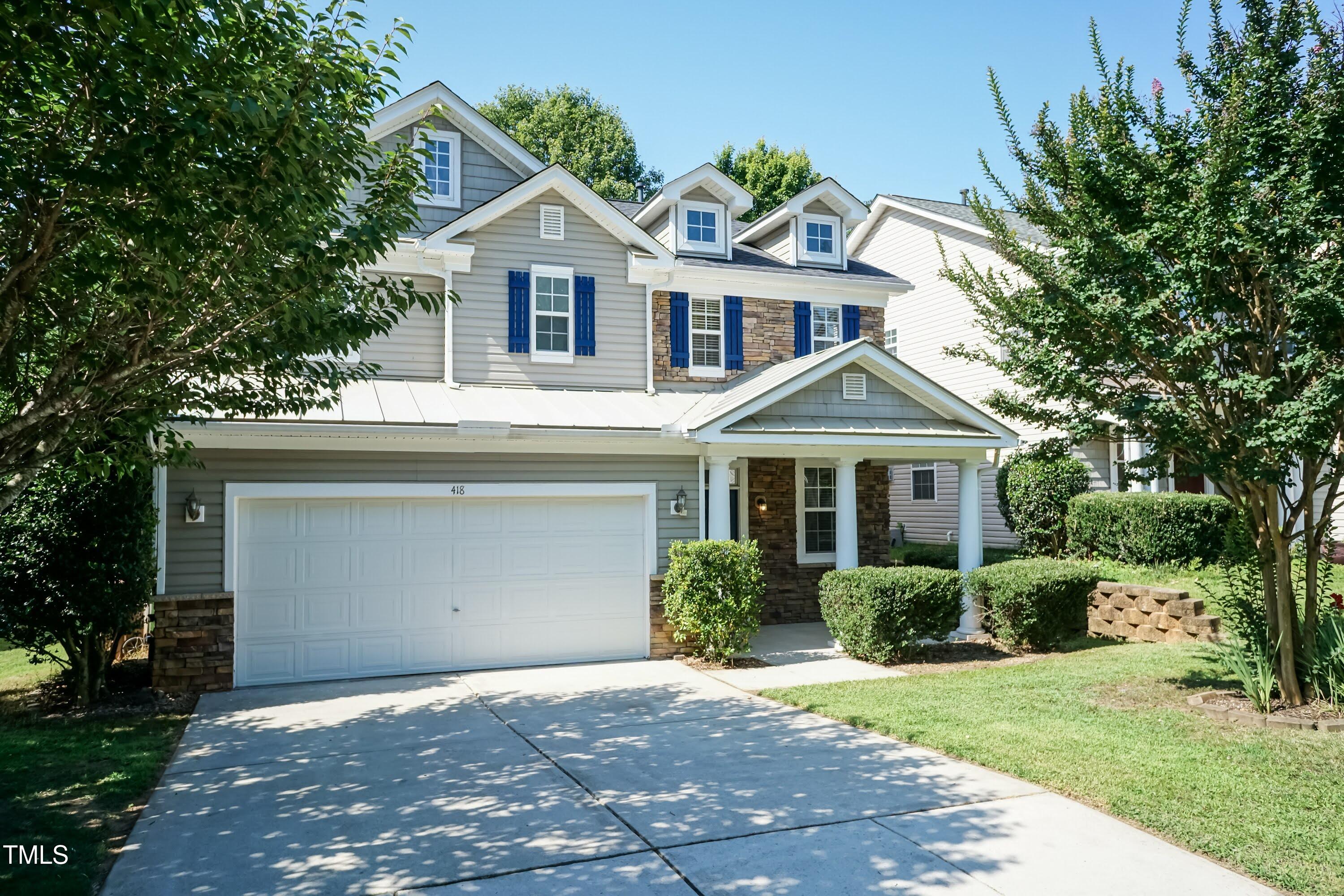 418 Byrams Ford Drive Cary, NC 27513 - Photo 2 of 53 a front view of a house with a garden and trees