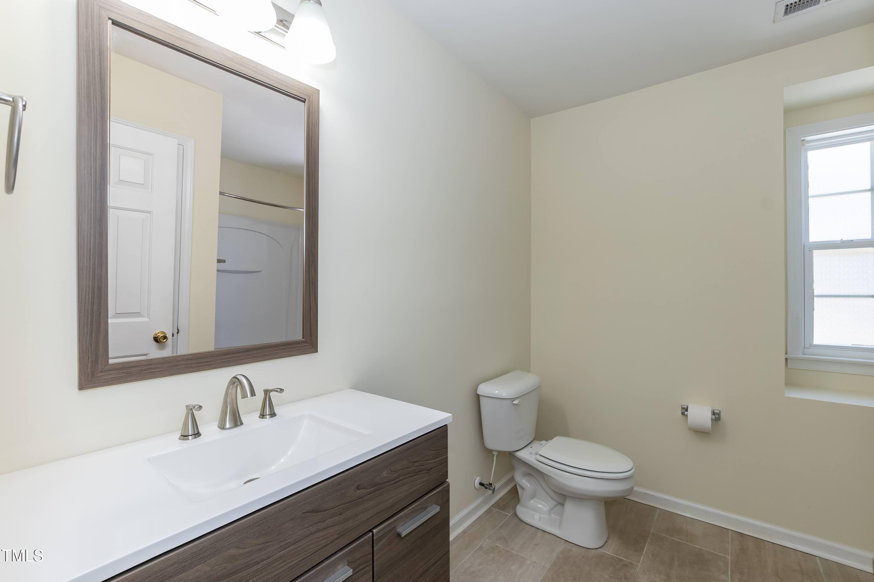 418 Byrams Ford Drive Cary, NC 27513 - Photo 31 of 53 a bathroom with a sink vanity mirror and toilet