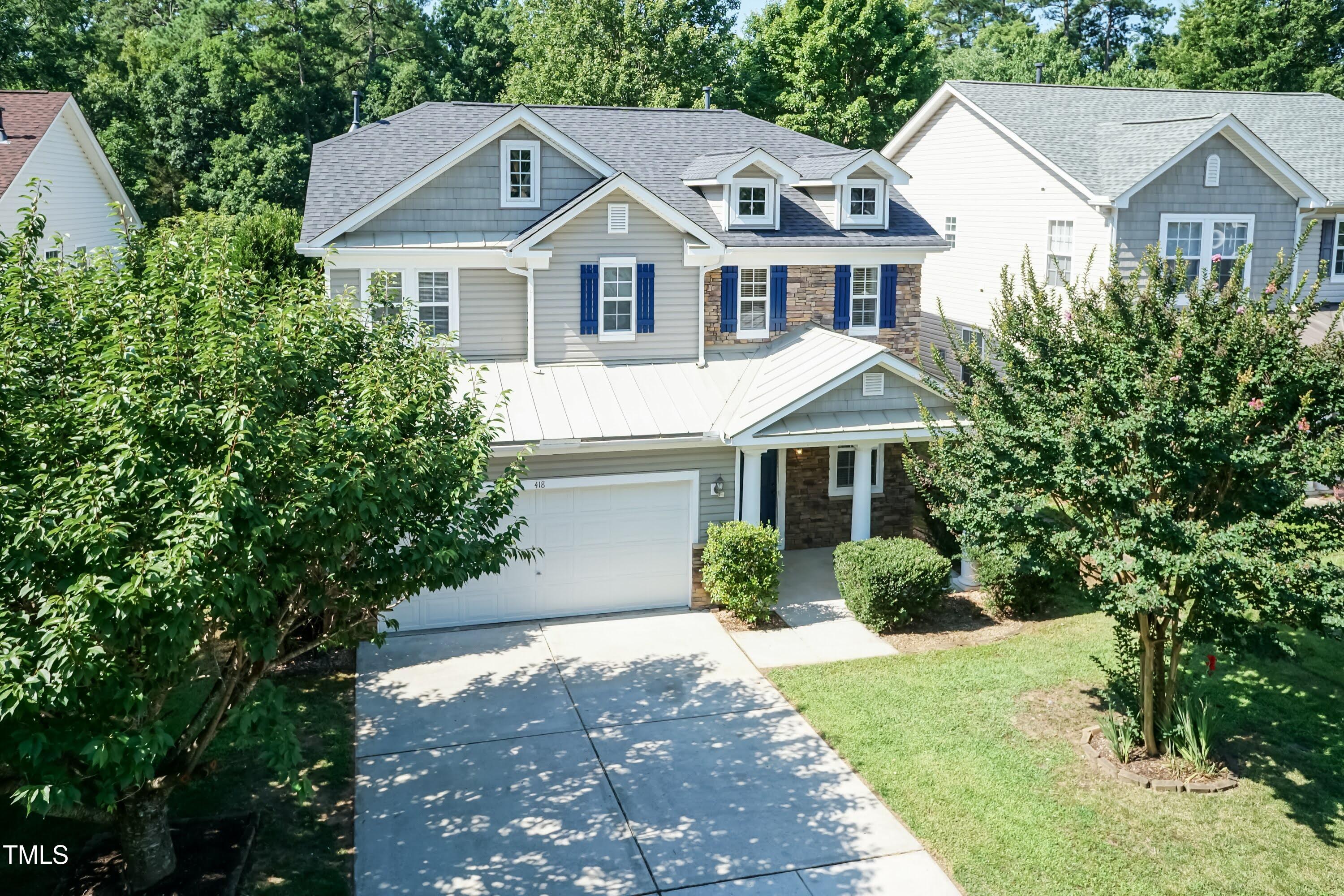 418 Byrams Ford Drive Cary, NC 27513 - Photo 45 of 53 a front view of a house with a yard and potted plants