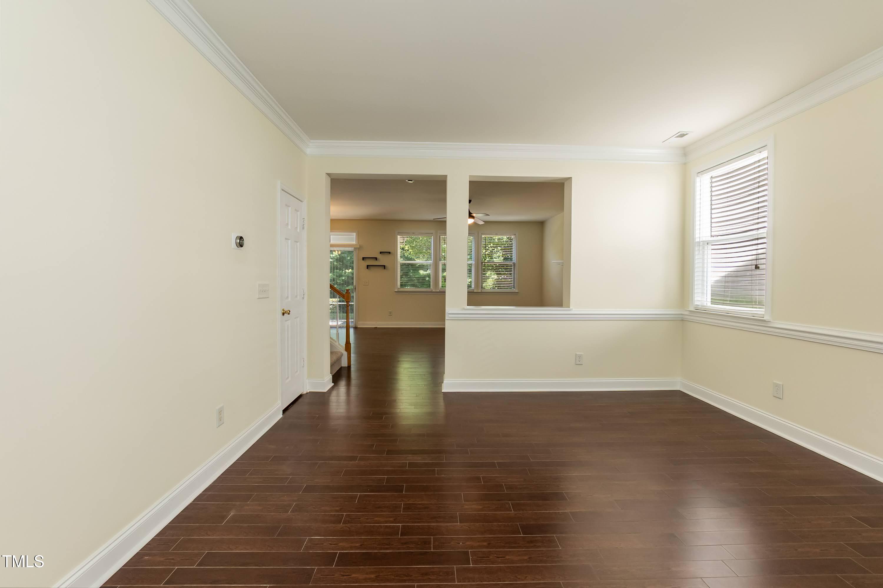 418 Byrams Ford Drive Cary, NC 27513 - Photo 5 of 53 a view of an empty room with wooden floor and a window