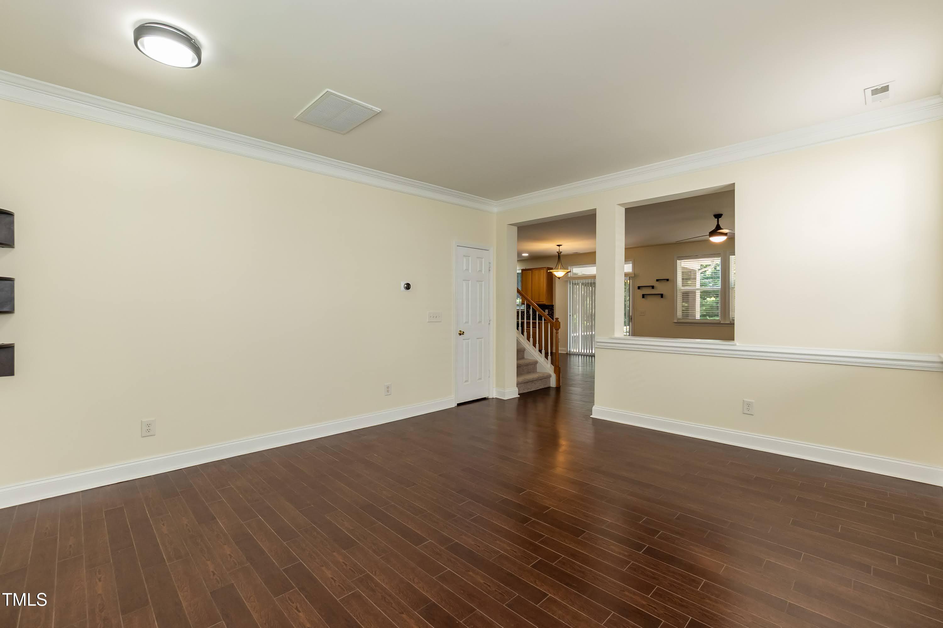 418 Byrams Ford Drive Cary, NC 27513 - Photo 6 of 53 an empty room with wooden floor and windows