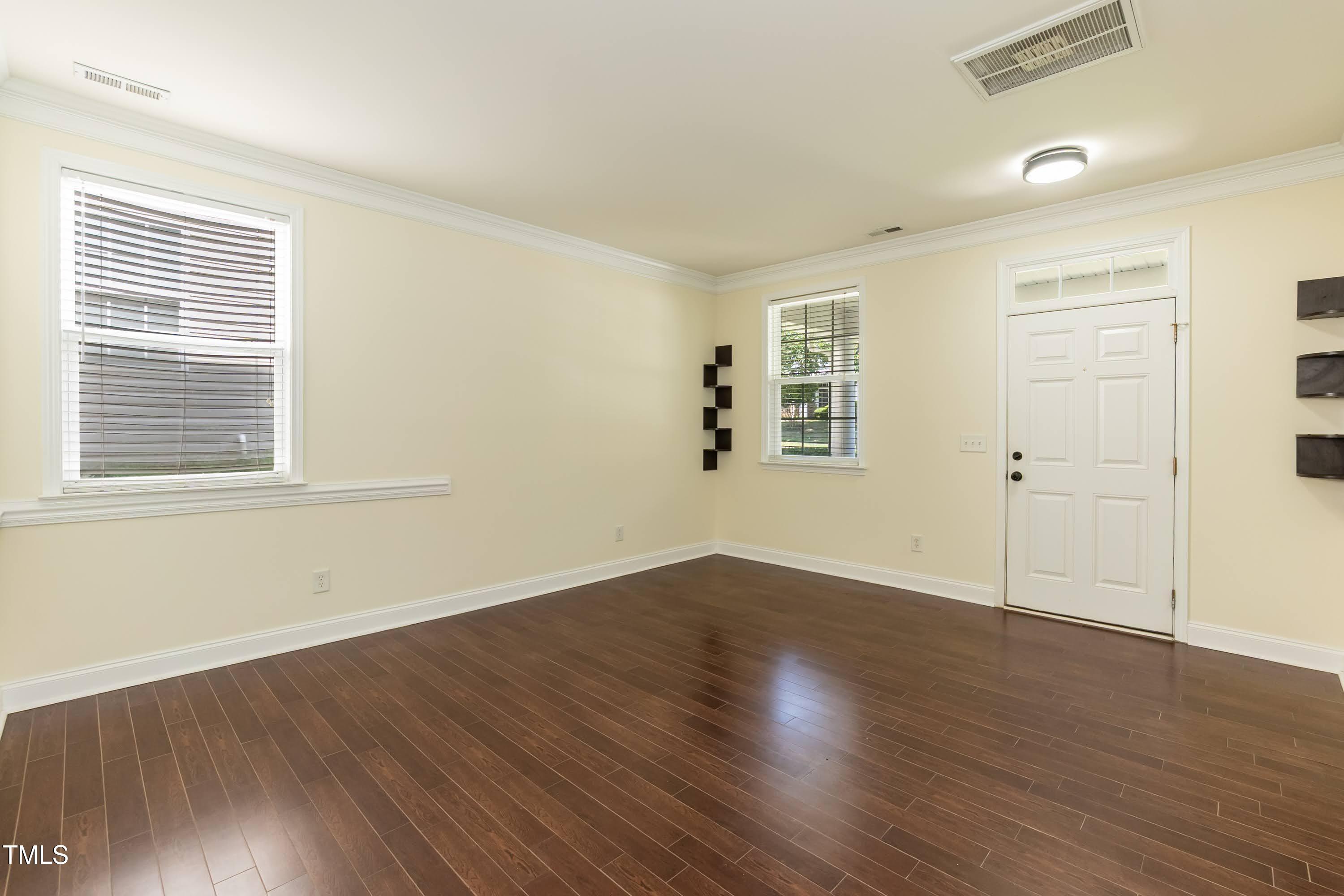 418 Byrams Ford Drive Cary, NC 27513 - Photo 7 of 53 an empty room with wooden floor and windows
