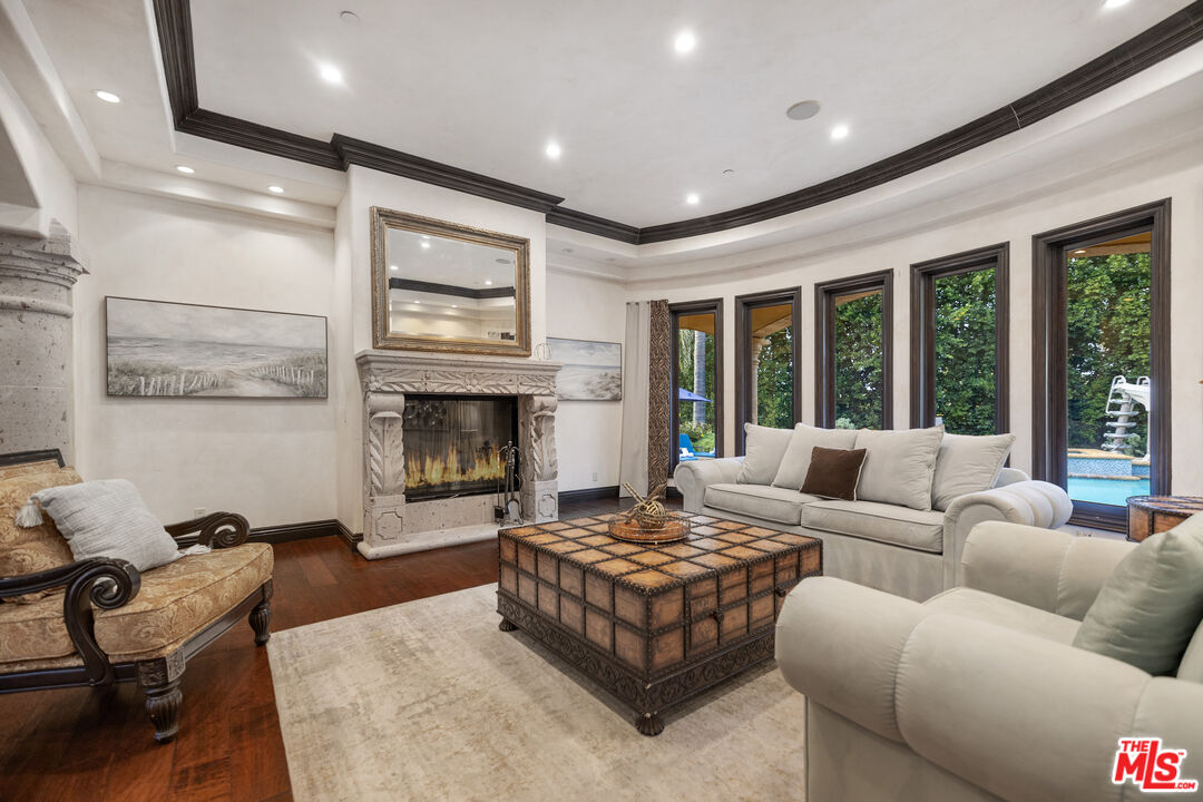 18607 Cassandra Street Tarzana, CA 91356 - Photo 14 of 58 a living room with furniture large window and a fireplace