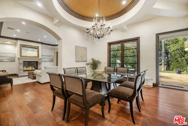 a view of a dining room with furniture wooden floor and chandelier