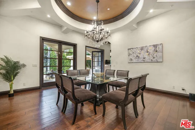 a large white kitchen with a large counter top and stainless steel appliances