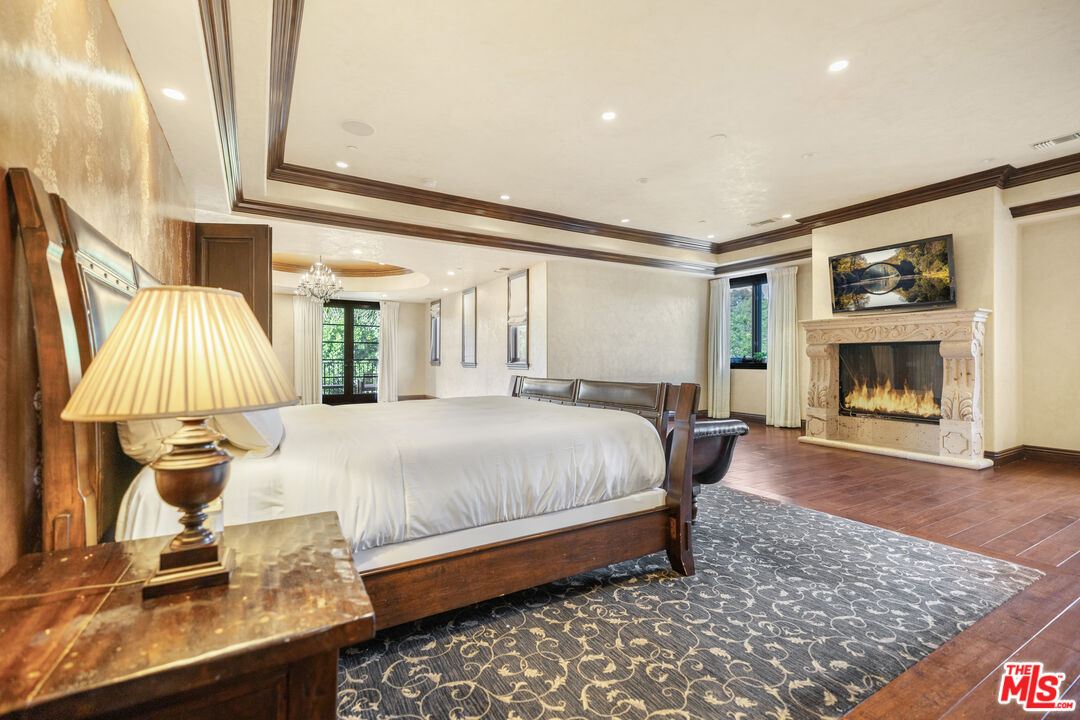 18607 Cassandra Street Tarzana, CA 91356 - Photo 25 of 58 a bedroom with a bed and a fireplace