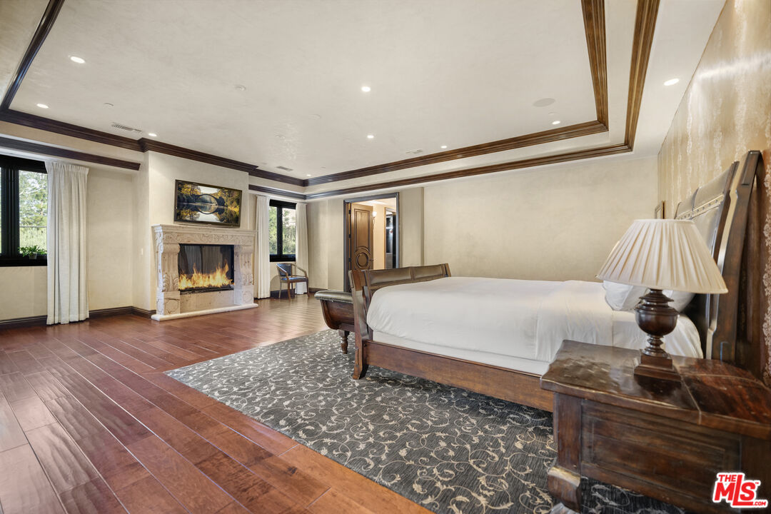 18607 Cassandra Street Tarzana, CA 91356 - Photo 26 of 58 a bedroom with a bed and wooden floor