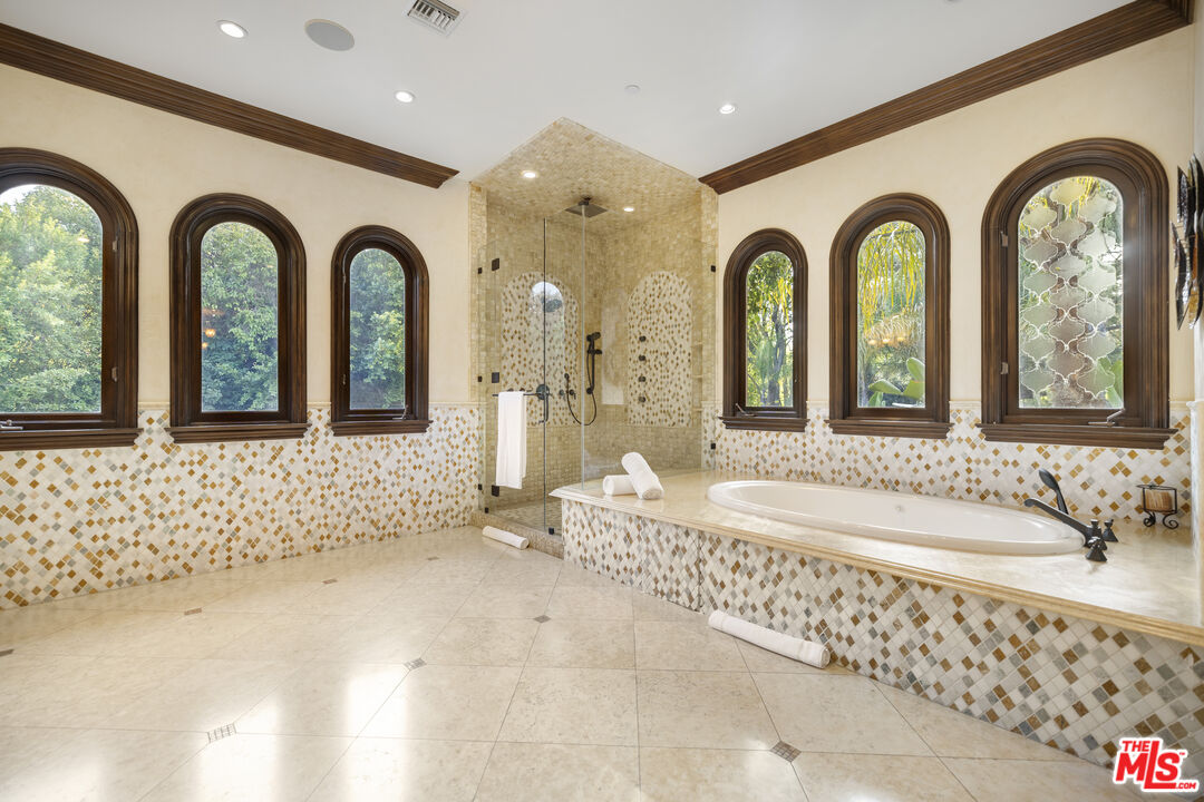 18607 Cassandra Street Tarzana, CA 91356 - Photo 27 of 58 a bathroom with a double vanity sink mirror and shower