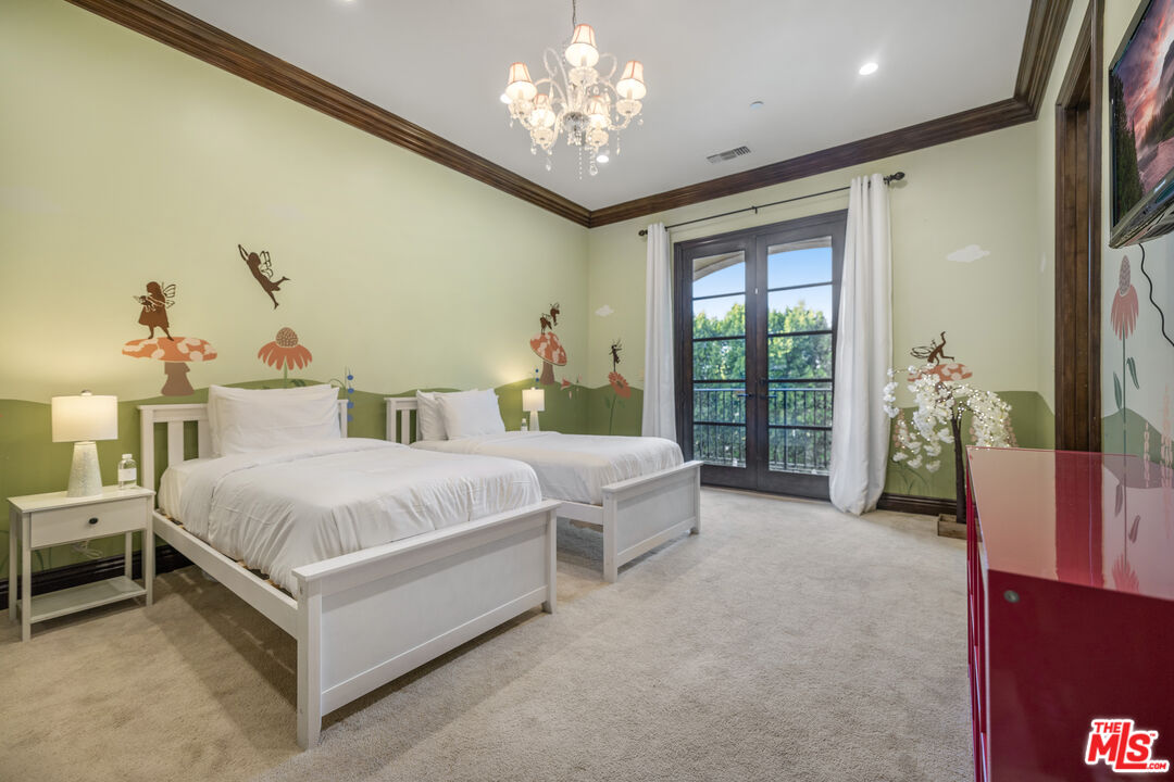 18607 Cassandra Street Tarzana, CA 91356 - Photo 34 of 58 a spacious bedroom with a bed and a chandelier