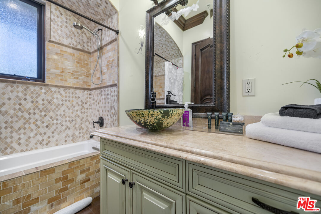 18607 Cassandra Street Tarzana, CA 91356 - Photo 35 of 58 a bathroom with a sink and a mirror