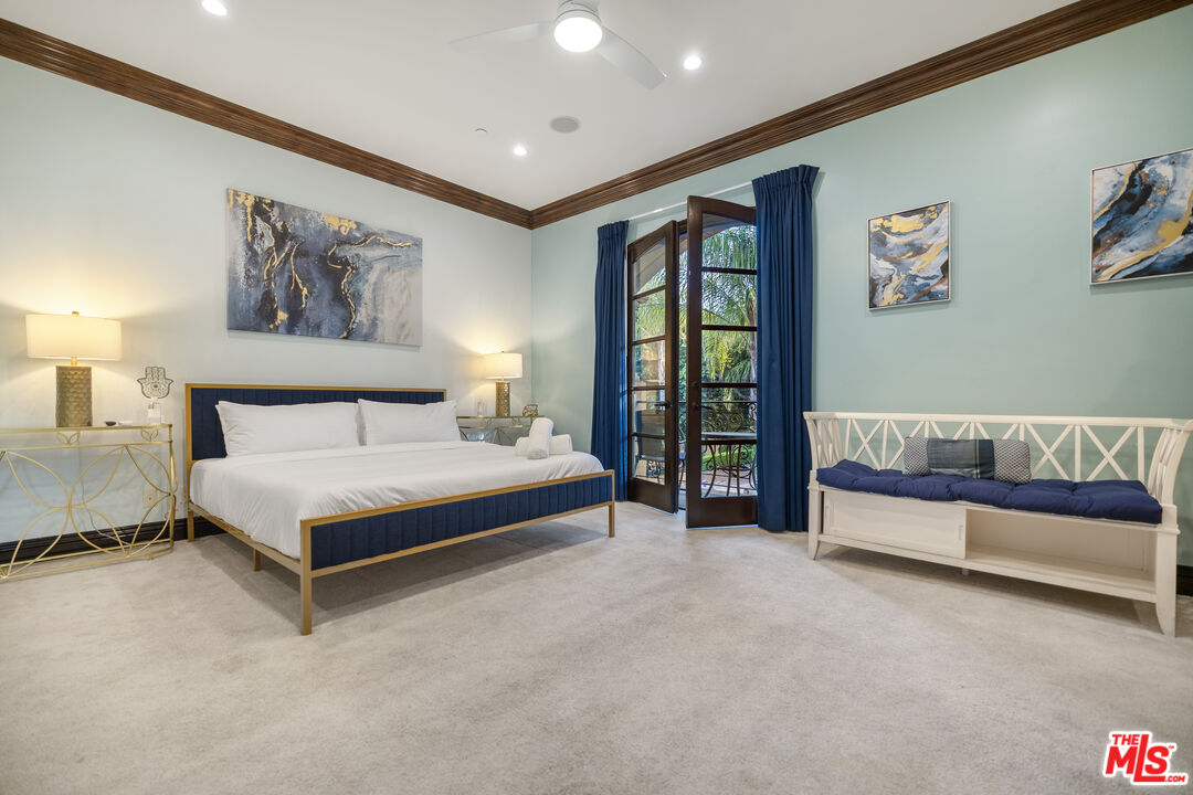 18607 Cassandra Street Tarzana, CA 91356 - Photo 38 of 58 a spacious bedroom with a large bed and a painting on the wall