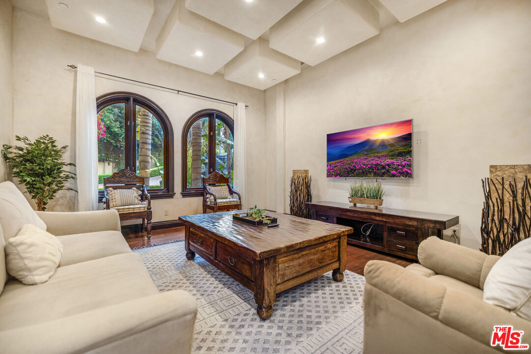 18607 Cassandra Street Tarzana, CA 91356 - Photo 4 of 58 a living room with furniture a flat screen tv and a large window
