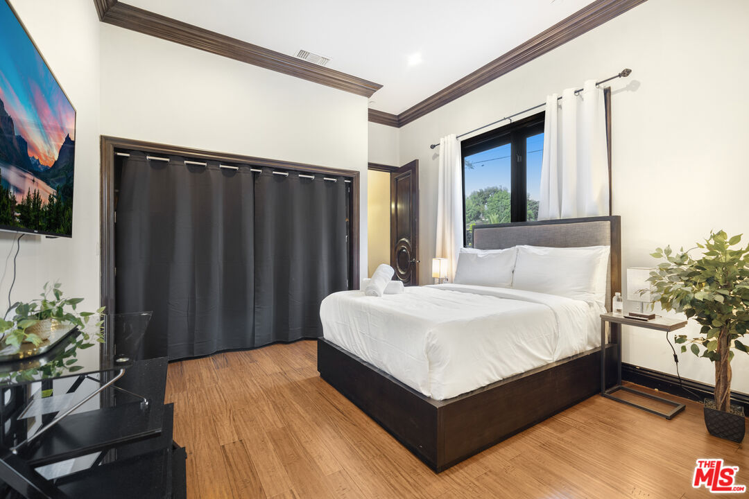 18607 Cassandra Street Tarzana, CA 91356 - Photo 41 of 58 a bed sitting in a bedroom next to a window