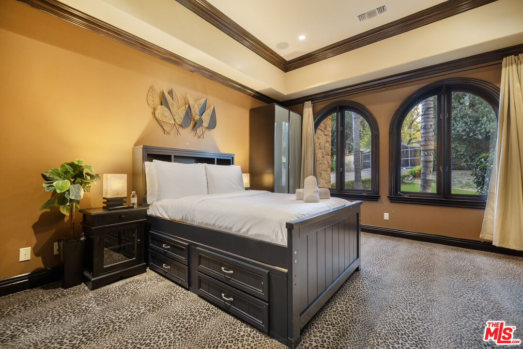 18607 Cassandra Street Tarzana, CA 91356 - Photo 45 of 58 a bedroom with a bed and a painting on the wall