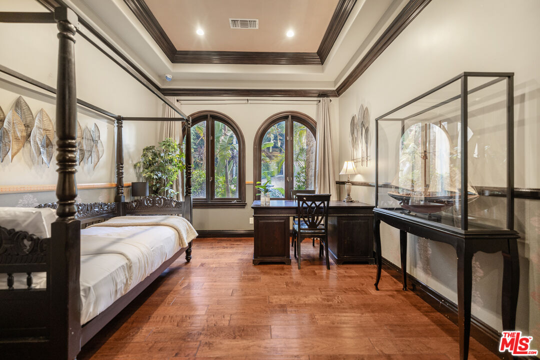18607 Cassandra Street Tarzana, CA 91356 - Photo 47 of 58 a living room with large windows and a chandelier